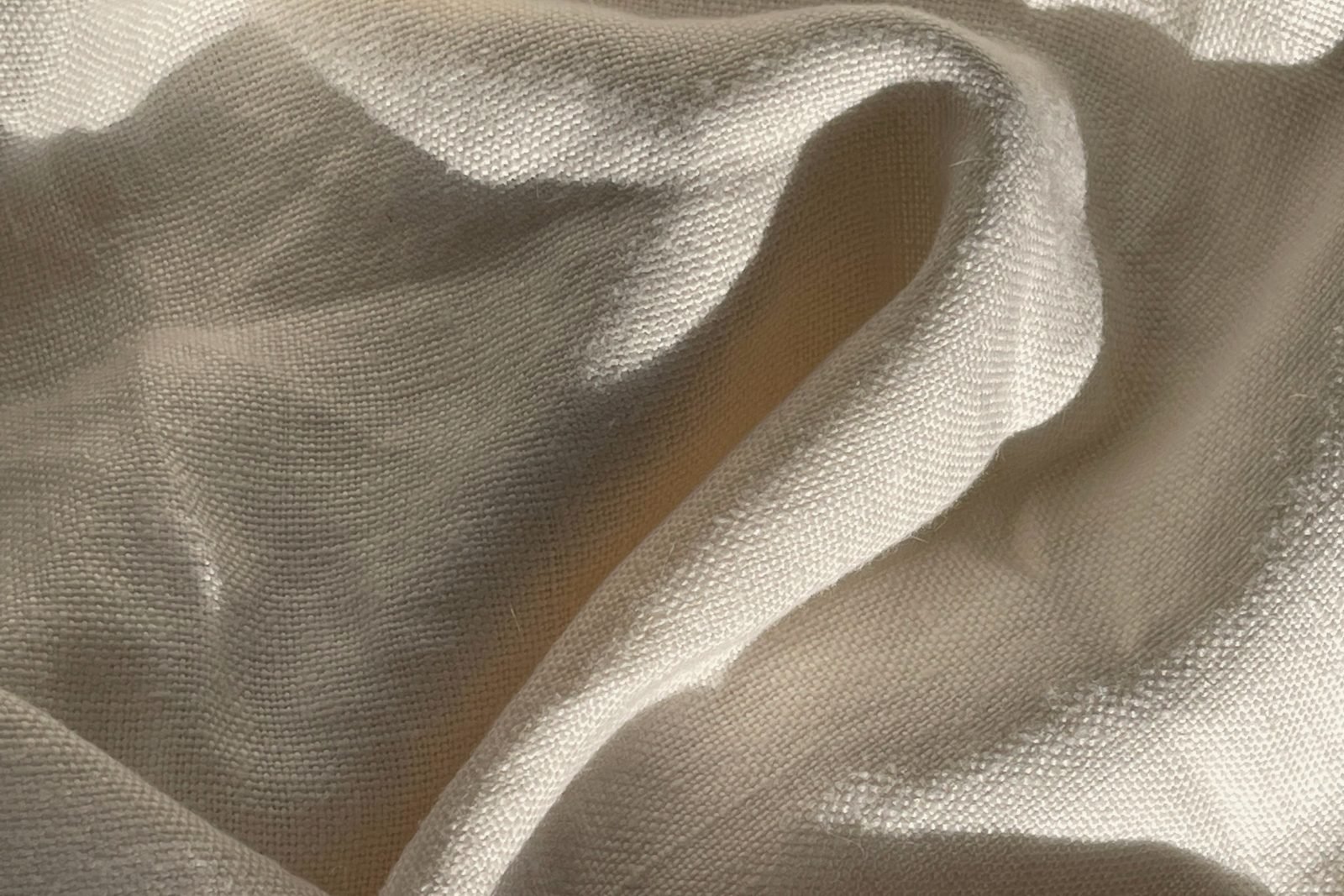 Warm sunlit folds of white linen