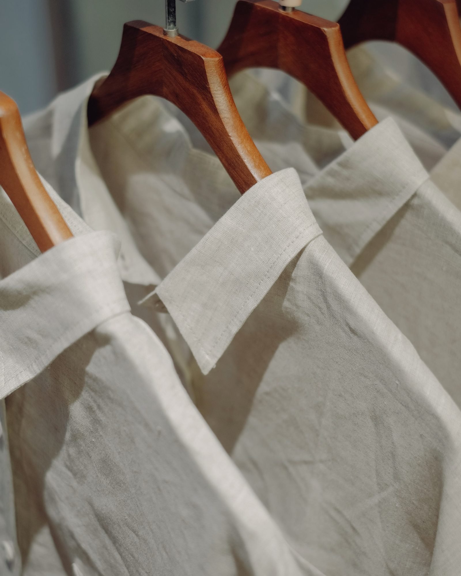 Pressed shirts on wooden hangers, collars in a neat row