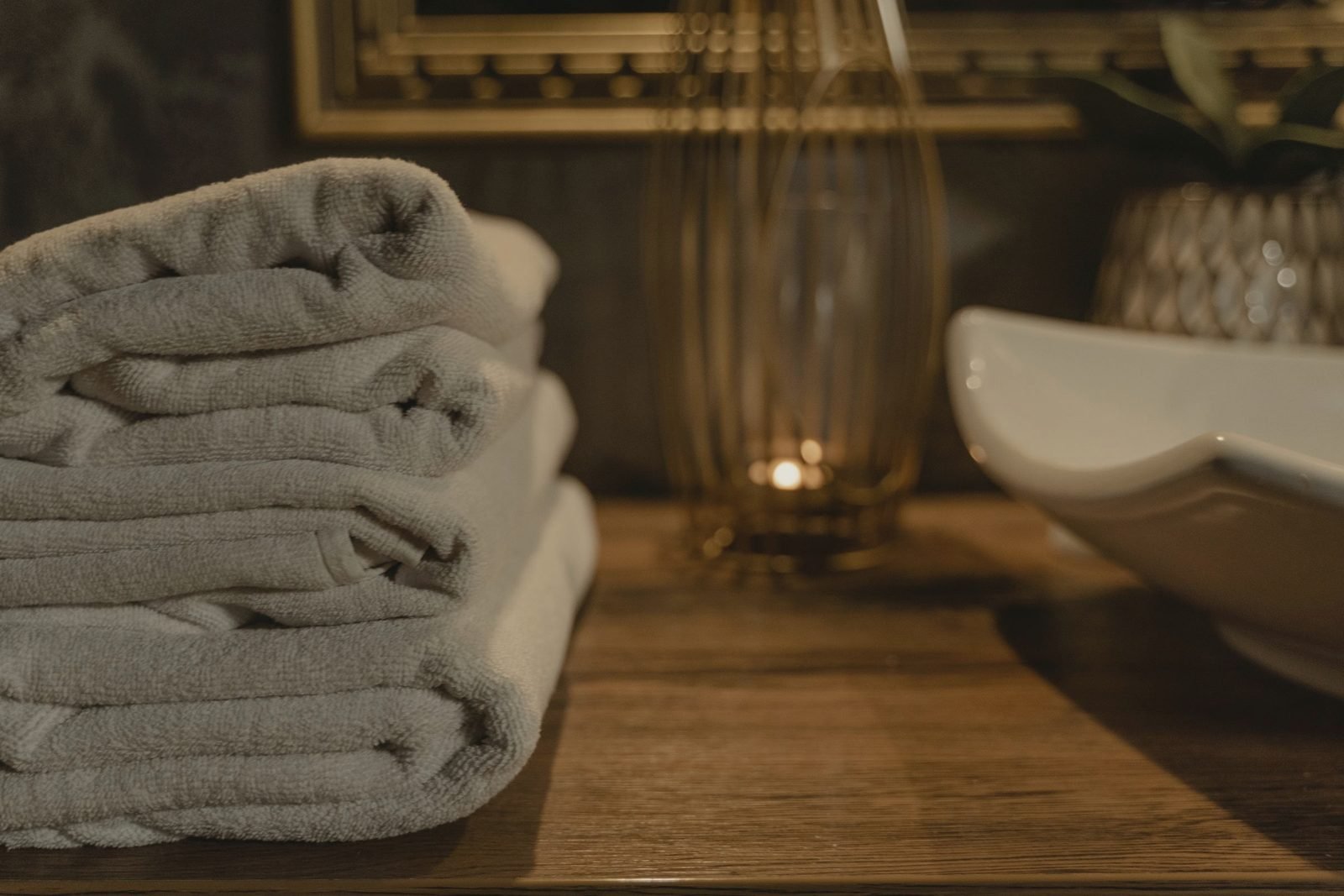 Folded towels stacked on a wooden counter